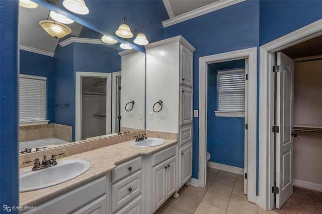 bathroom with tile patterned flooring, a sink, toilet, and crown molding