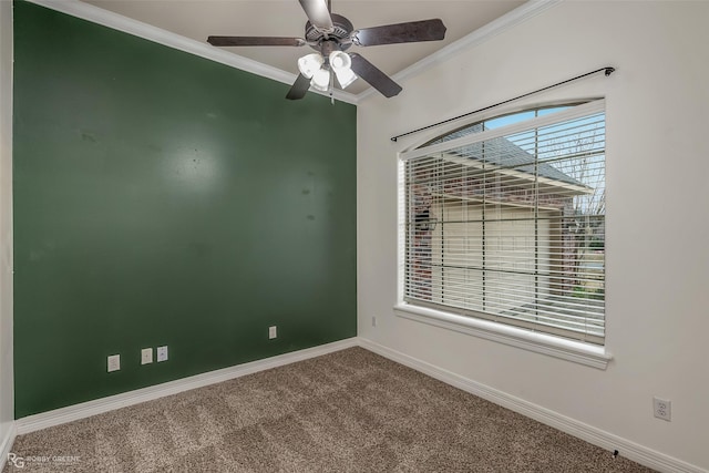 carpeted spare room with baseboards, ornamental molding, and ceiling fan