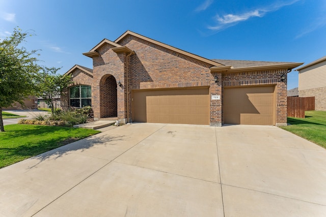 view of front of property with a garage, a front lawn, concrete driveway, and brick siding