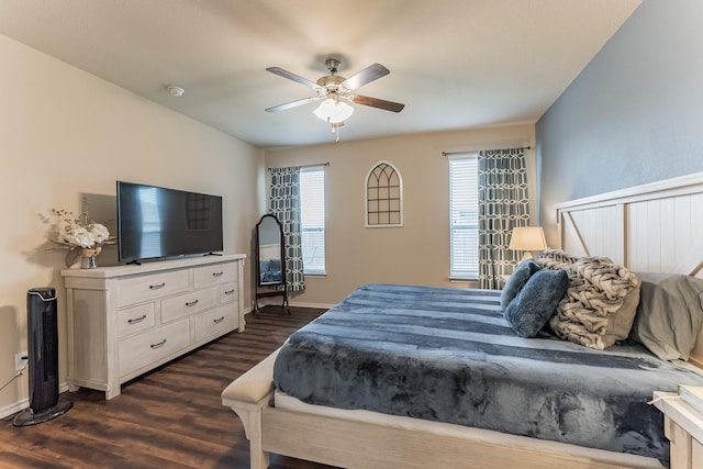 bedroom with baseboards, a ceiling fan, and dark wood-type flooring