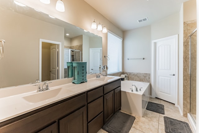 full bath featuring a garden tub, tile patterned flooring, a sink, visible vents, and a shower stall