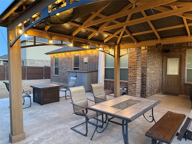 view of patio with a gazebo, an outdoor fire pit, and fence