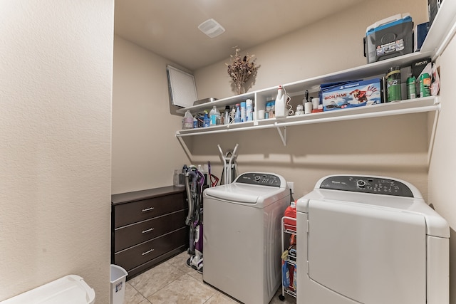 clothes washing area with tile patterned floors, laundry area, visible vents, and separate washer and dryer