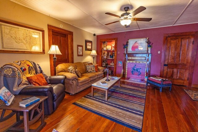 living room featuring a ceiling fan and hardwood / wood-style floors