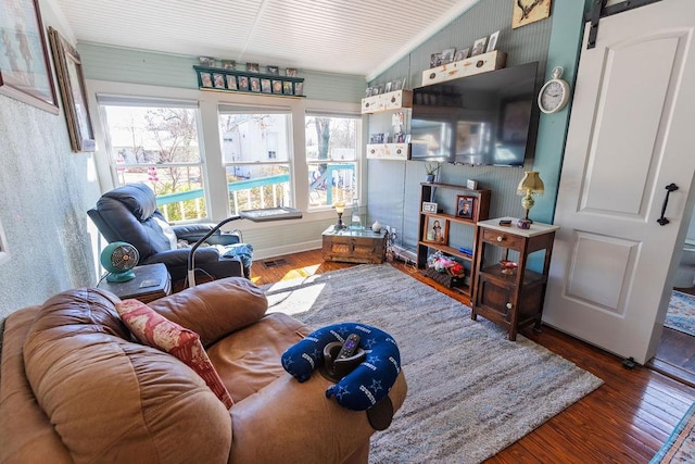 living area featuring visible vents, a barn door, and hardwood / wood-style floors