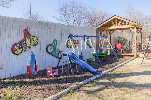 view of jungle gym featuring fence