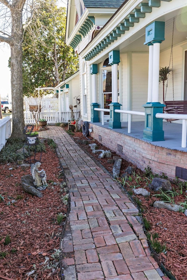 view of patio with a porch and fence