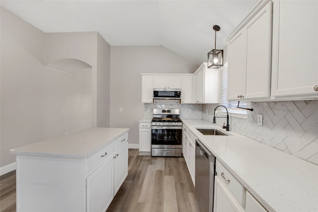 kitchen featuring white cabinets, light wood-style floors, appliances with stainless steel finishes, and a sink