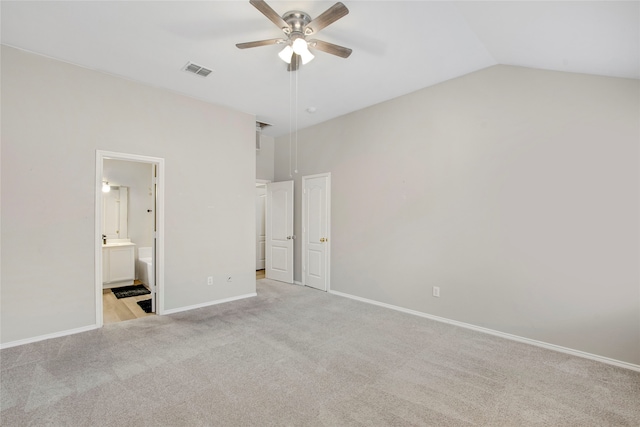 unfurnished bedroom with visible vents, ensuite bath, baseboards, lofted ceiling, and light colored carpet