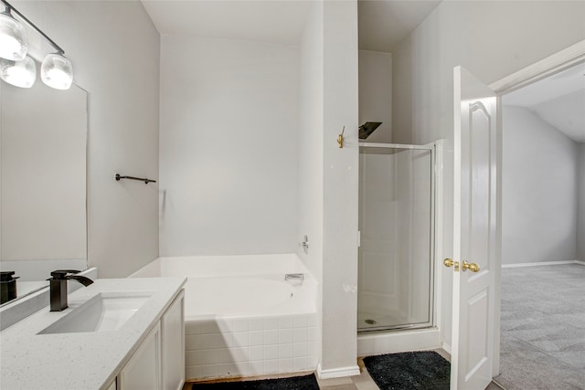 full bathroom featuring a shower stall, vanity, and a garden tub