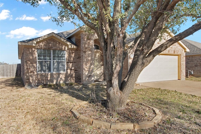 view of home's exterior featuring brick siding, fence, concrete driveway, a lawn, and an attached garage