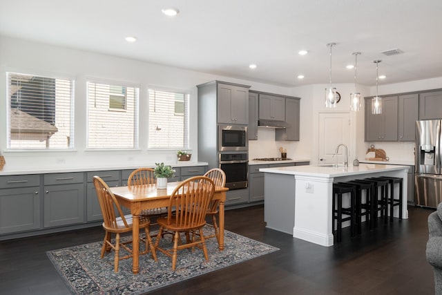 1624 Thunderbird Dr, Fort Worth, TX 76052 - kitchen with a kitchen breakfast bar, visible vents, gray cabinets, a kitchen island with sink, and appliances with stainless steel finishes