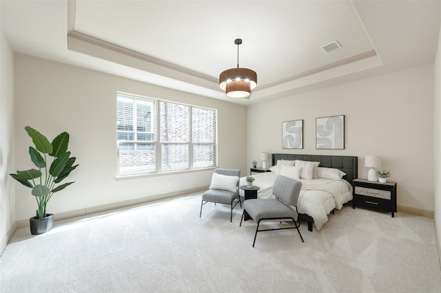 bedroom featuring baseboards, a tray ceiling, visible vents, and light colored carpet