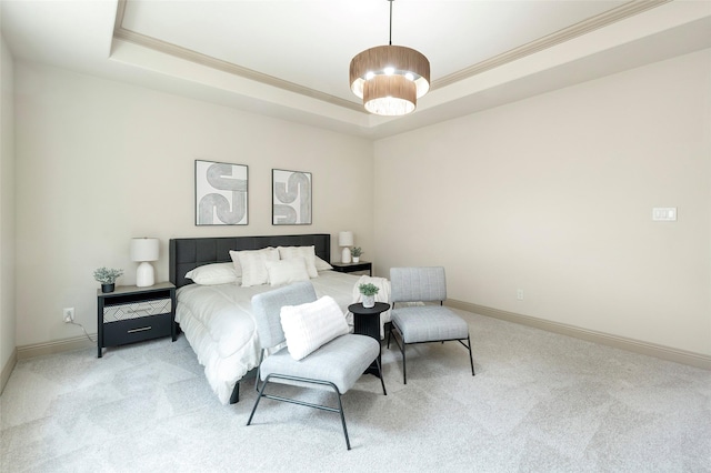 bedroom featuring a raised ceiling, light carpet, and baseboards