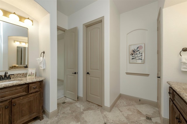 full bathroom featuring vanity and baseboards