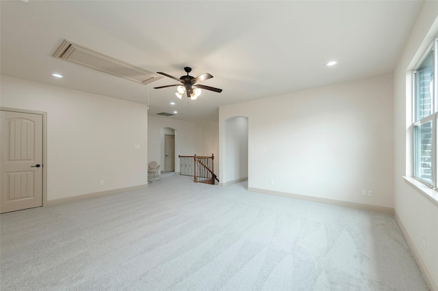 spare room featuring arched walkways, recessed lighting, visible vents, baseboards, and attic access