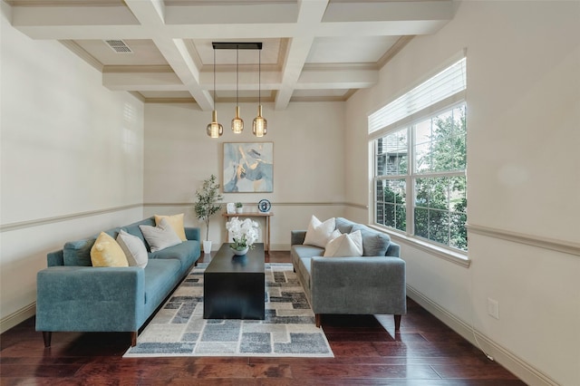 living area featuring beamed ceiling, hardwood / wood-style flooring, visible vents, and baseboards