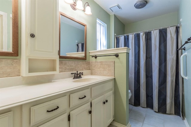 full bathroom with visible vents, toilet, decorative backsplash, vanity, and tile patterned floors