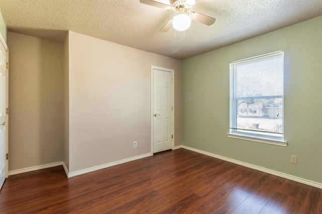 empty room featuring dark wood-type flooring and baseboards