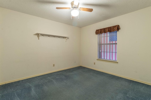 empty room with dark carpet, a textured ceiling, baseboards, and ceiling fan