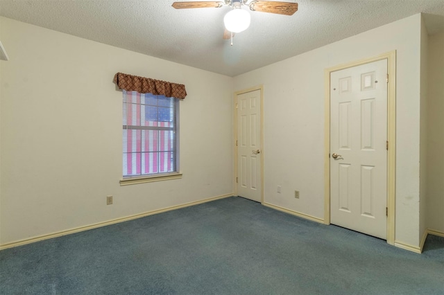 unfurnished room featuring carpet, baseboards, ceiling fan, and a textured ceiling