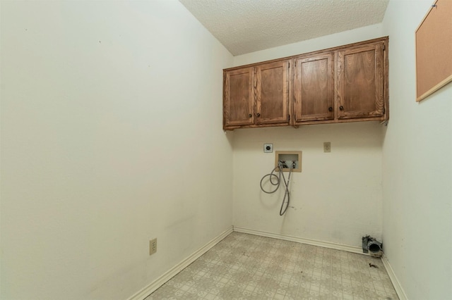 laundry room featuring cabinet space, baseboards, light floors, washer hookup, and electric dryer hookup