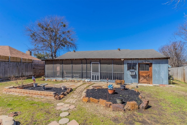 back of property featuring a fenced backyard and a sunroom