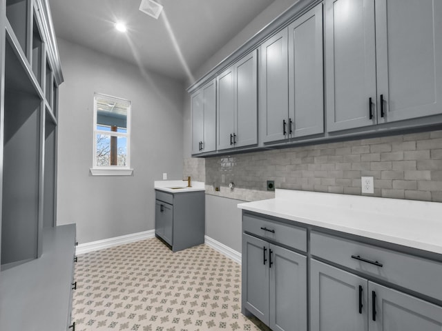 laundry room with cabinet space, visible vents, baseboards, hookup for an electric dryer, and light floors