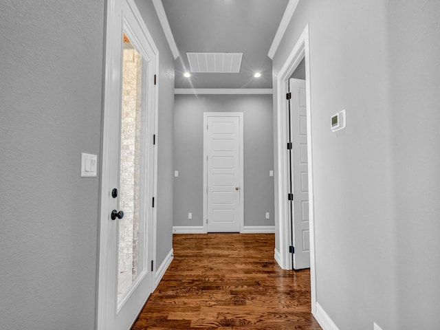 hallway featuring recessed lighting, wood finished floors, visible vents, baseboards, and ornamental molding