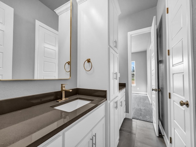 bathroom with baseboards and vanity