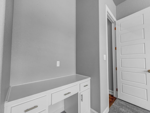 interior space featuring carpet floors and baseboards