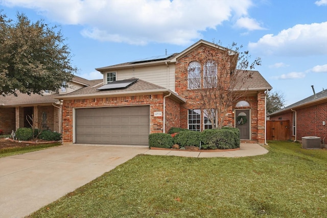 traditional-style house with a front yard, brick siding, and driveway