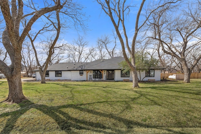 view of front of property with a front yard and fence