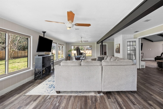 living area with dark wood-style flooring, visible vents, and baseboards