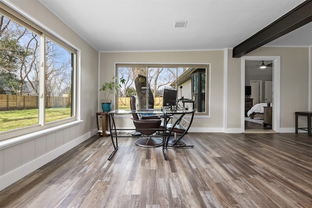 dining room featuring visible vents, baseboards, wood finished floors, and ornamental molding