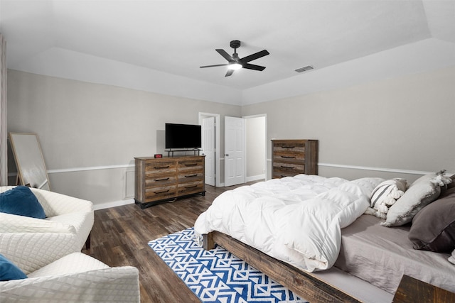 bedroom with vaulted ceiling, ceiling fan, dark wood-style floors, and visible vents