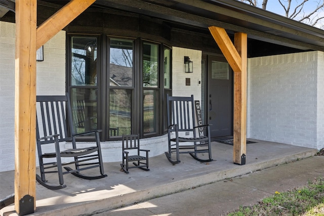 view of exterior entry featuring covered porch