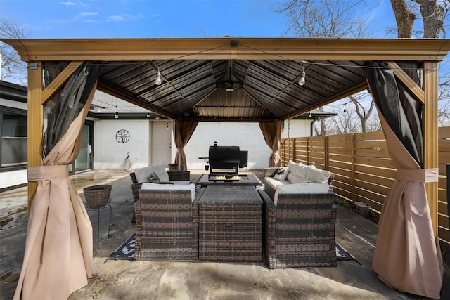 view of patio / terrace with an outdoor hangout area, a gazebo, and fence