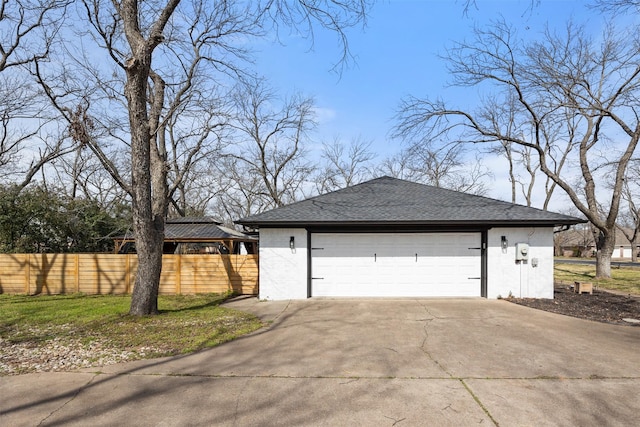 exterior space featuring concrete driveway and fence