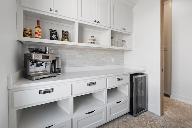 bar with brick floor, beverage cooler, baseboards, and backsplash