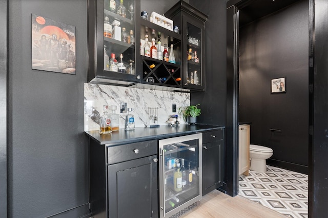 bar with a dry bar, wine cooler, and backsplash