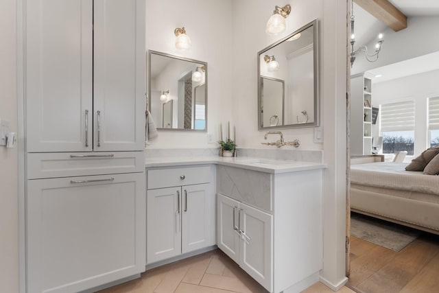 bathroom with lofted ceiling with beams, tile patterned floors, ensuite bath, and vanity