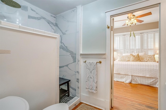 bathroom with wood finished floors, ceiling fan, toilet, and walk in shower