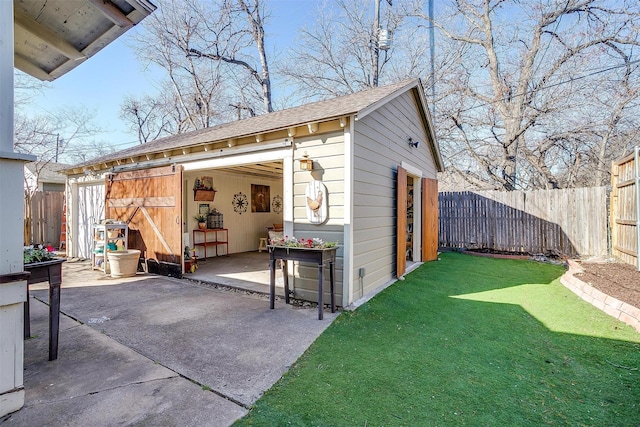 view of outbuilding with an outdoor structure and fence