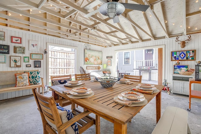 dining area with unfinished concrete floors and a ceiling fan