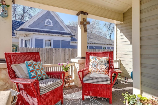 deck with a porch and fence