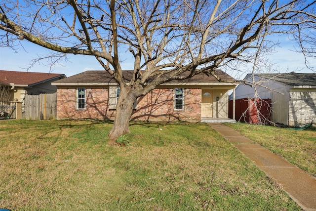 single story home with brick siding, fence, and a front lawn