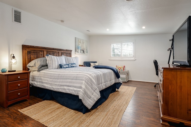 bedroom featuring baseboards, visible vents, dark wood-type flooring, a textured ceiling, and recessed lighting