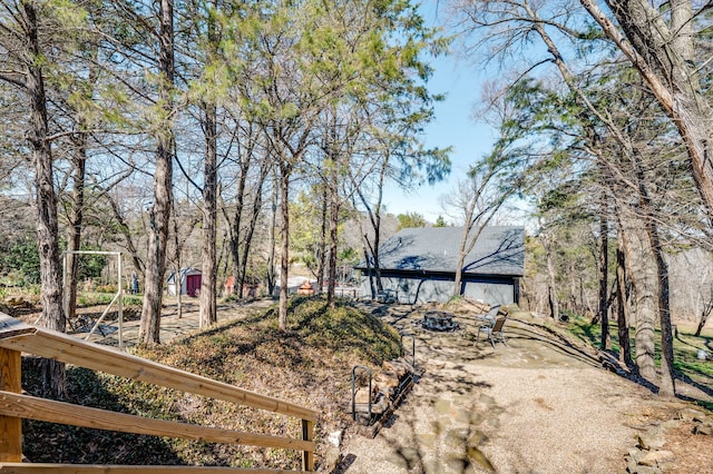 view of yard featuring an outdoor fire pit