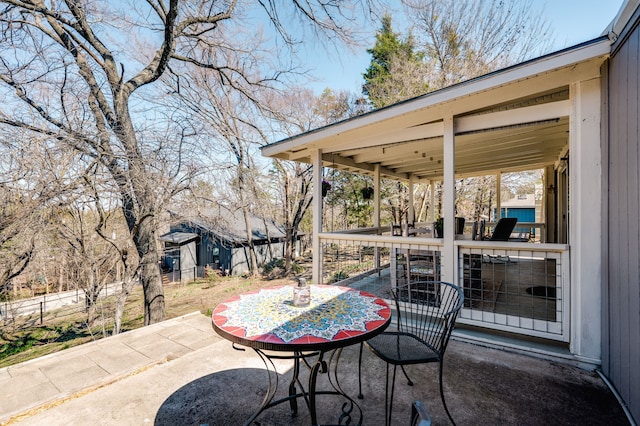 view of patio featuring fence and outdoor dining space